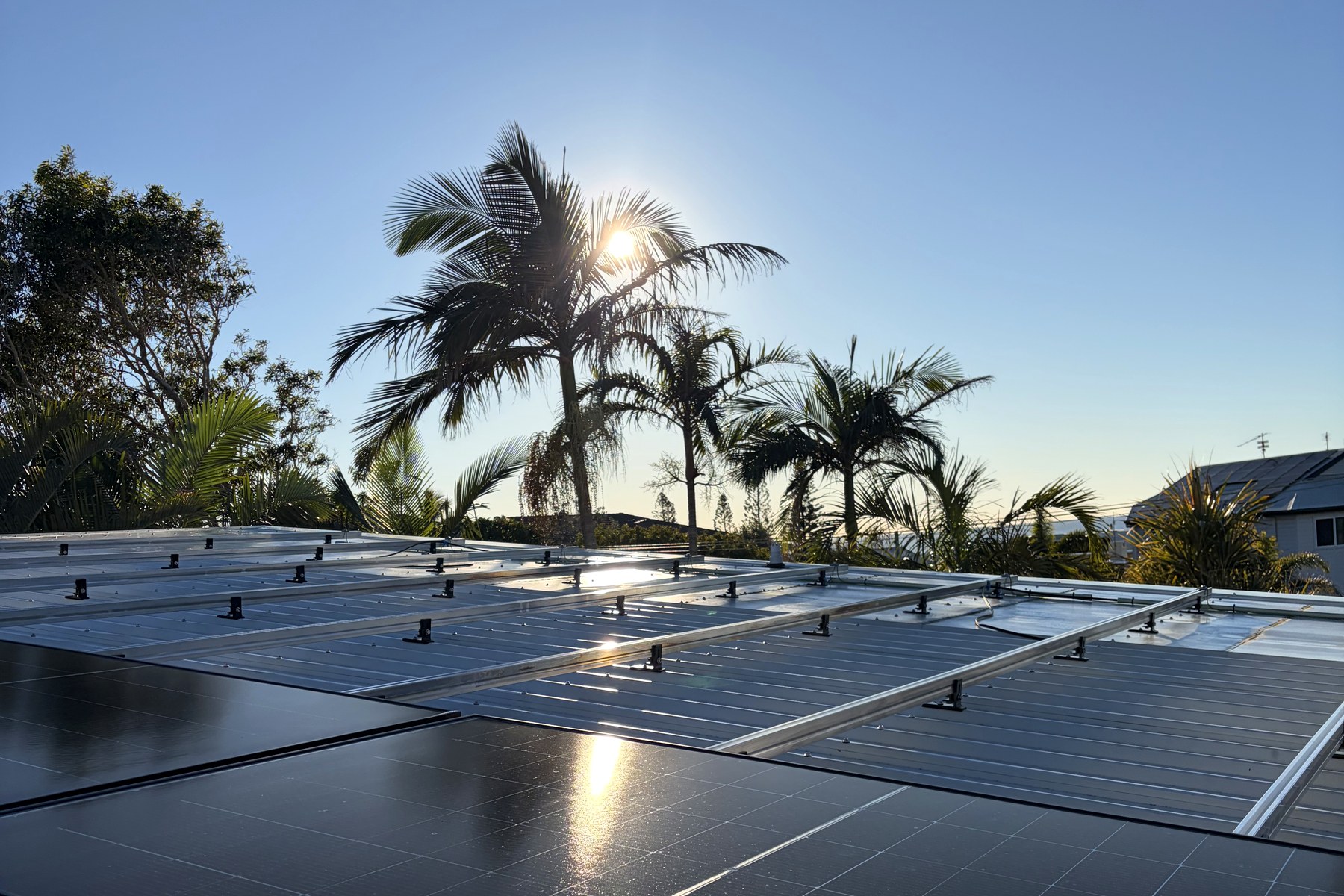Solar array installed on a Brisbane rooftop at golden hour